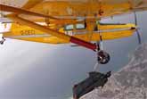 Wingsuit Pilot Passes By A Plane And Hands Off A Banana